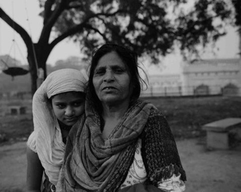 Migrant mother and daughter on the grounds of the Tile Wala Masjid
